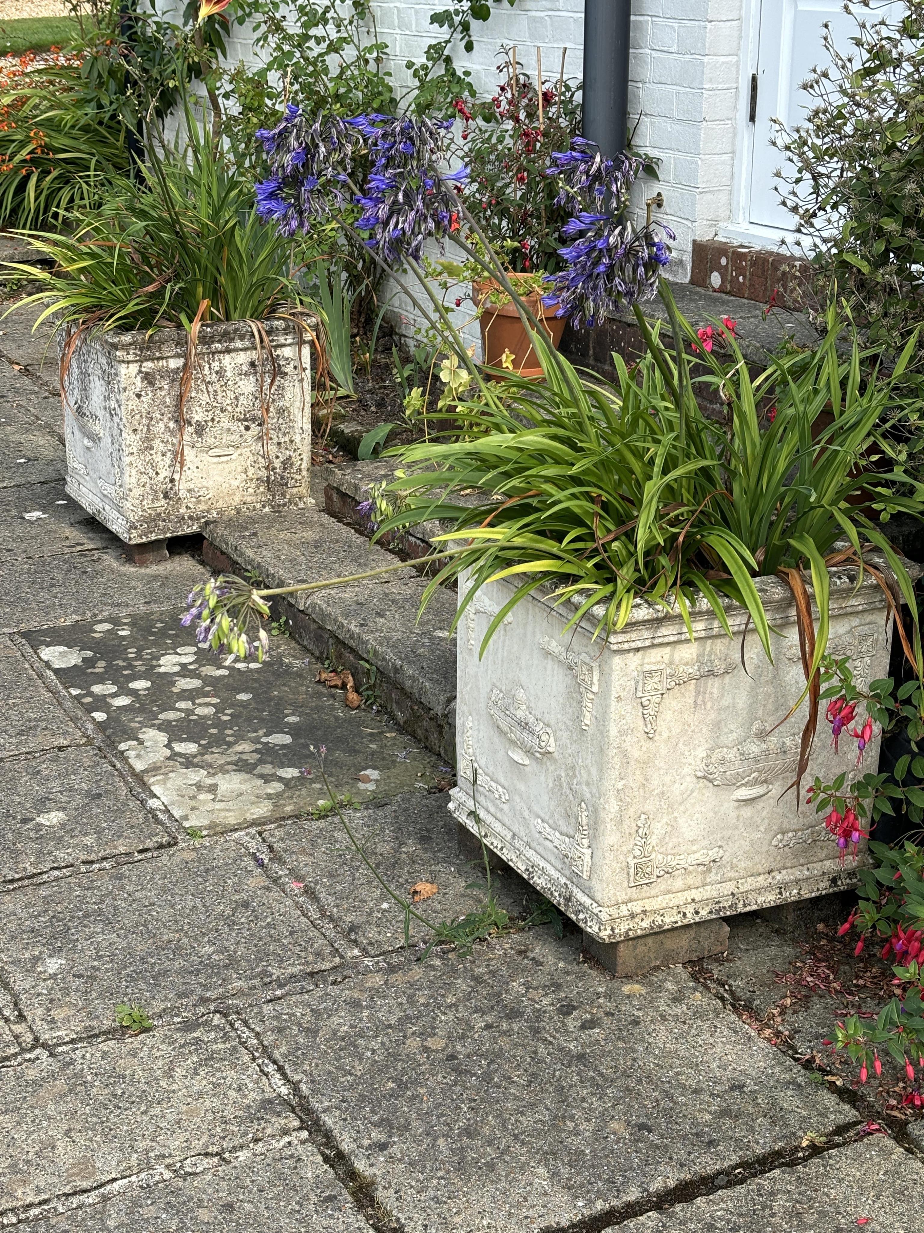 A pair of square reconstituted stone planters, height 50cm, width 50cm. planting removed, Condition - weathered, otherwise good